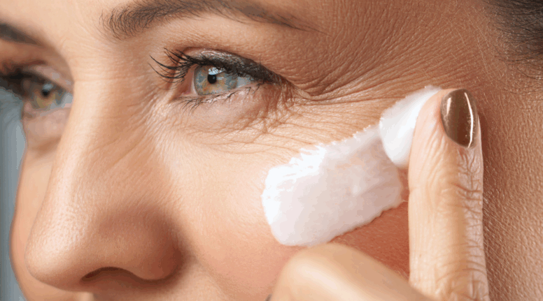 Close-up of mature woman applying anti-ageing cream around eye area – featured in Look Lovely London’s expert guide to supporting ageing skin.